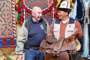 Randy Smith presents a Western saddle to Issyk-Kul governor Akhat Akibayev