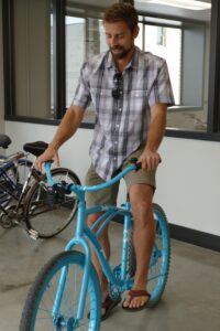 Hendrickson tests out one of the newly painted Mela bicycles