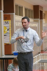 Sterling Middle School teacher Travis Kane explains the robotics after-school program.